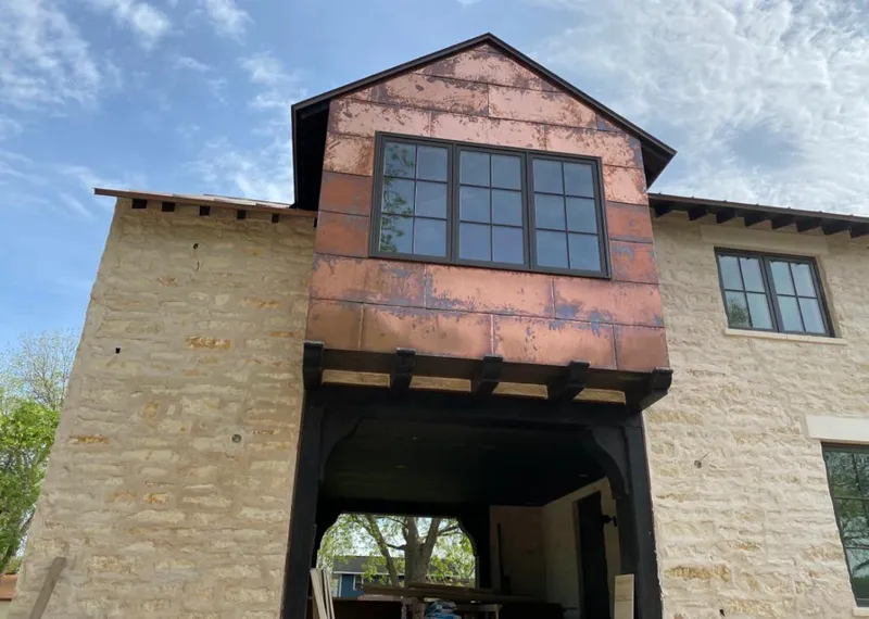 Copper metal panel facade on a stone building for Metal Roof Coating in Lafayette